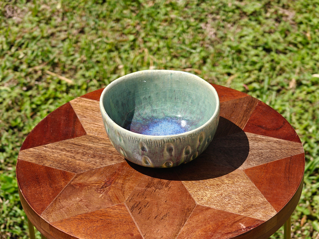 Ceramic bowl on a wooden table outdoors