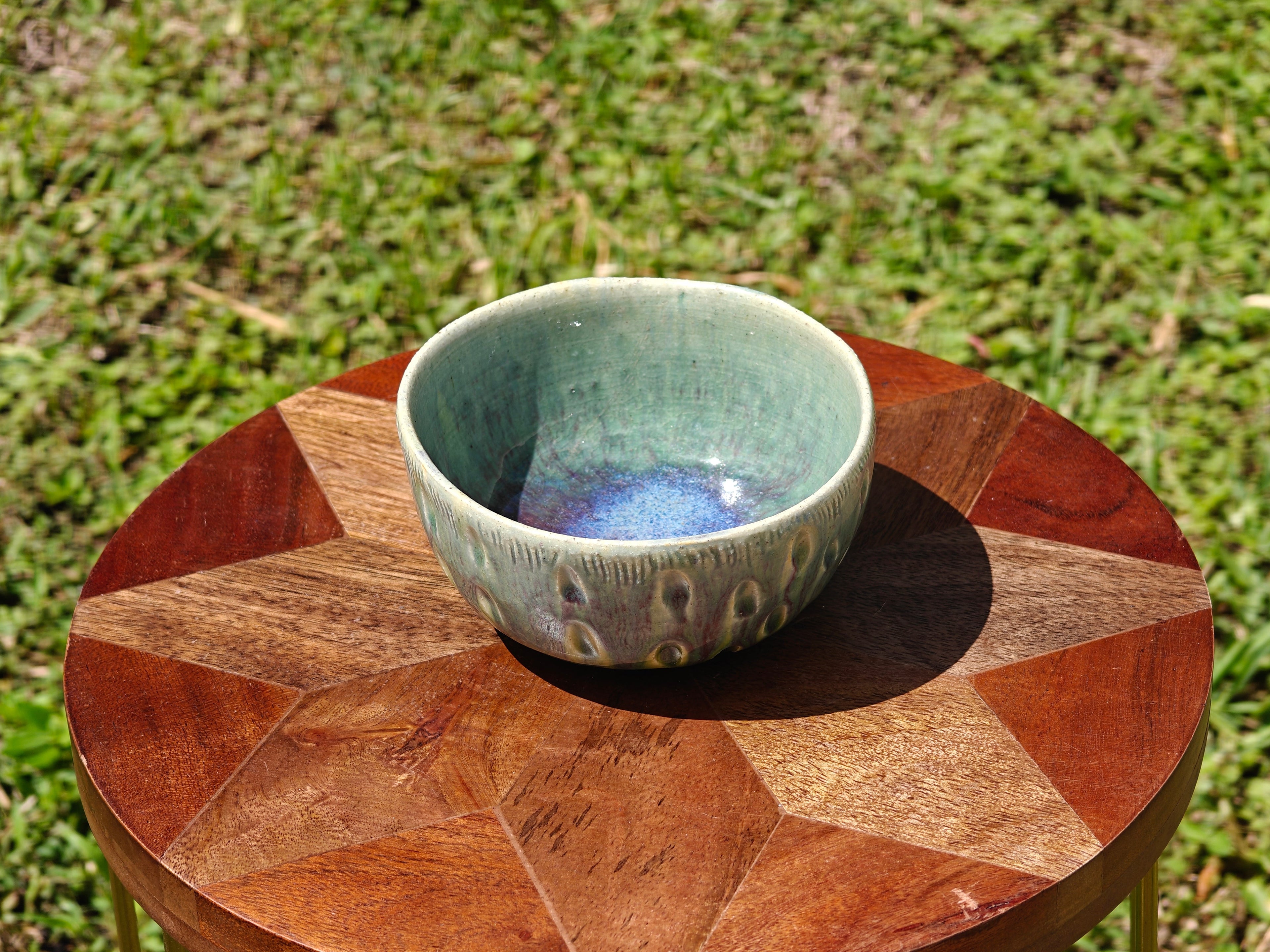 Ceramic bowl on a wooden table outdoors